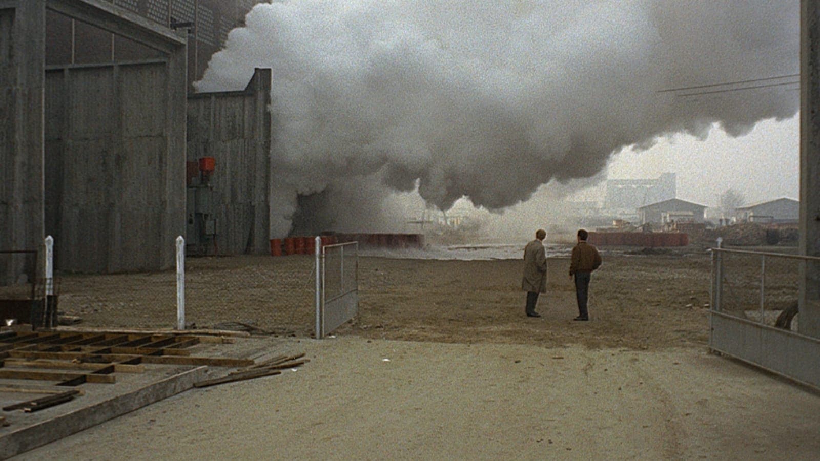 Giuliana (Monica Vitti) framed against Ravenna’s factories — yellow smoke and a grey-painted landscape, colour as pathology in Red Desert (1964).