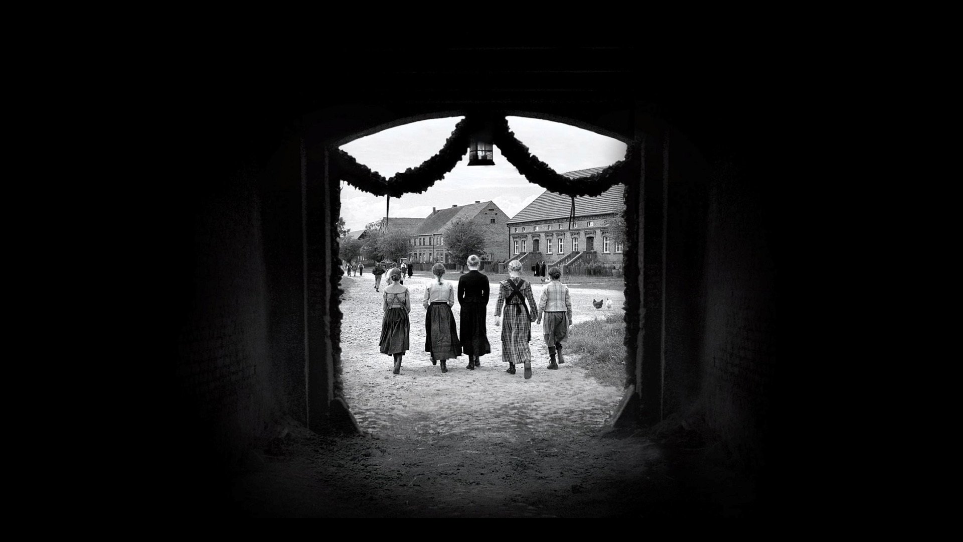 Children wearing white ribbons in a Protestant village; forensic black-and-white frames the weaponization of “purity” — Haneke’s *The White Ribbon* (2009).